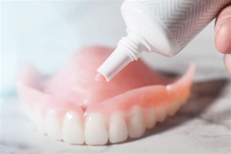 applying poligrip to upper dentures