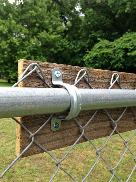 attach conduit to chain link fence
