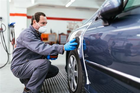 Auto Body Repair Shop Employee Fixing Car
