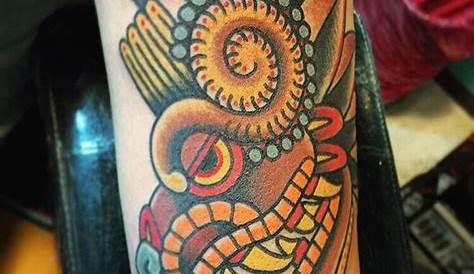Aztec feathered serpent and stone symbol tattoo on
