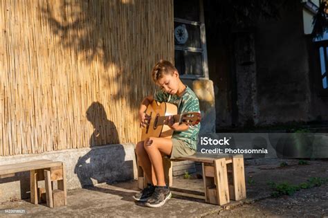 backyard boy on guitar