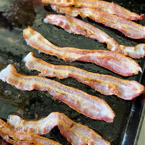 sizzling bacon on griddle