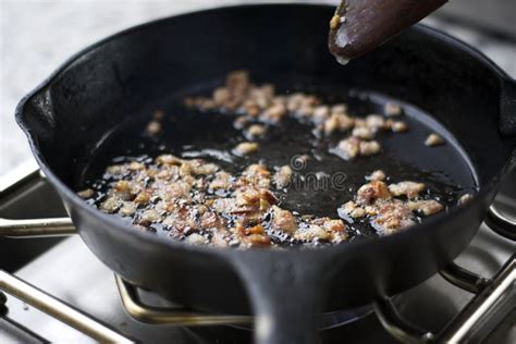 Bacon Bits Cooking in a Skillet