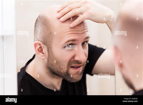 Bald Man Looking in Mirror
