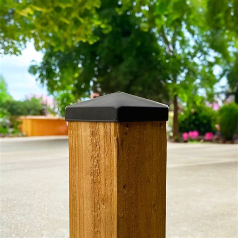 Baseball Caps On Fence Posts