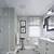bathroom with gray tile and white vanity