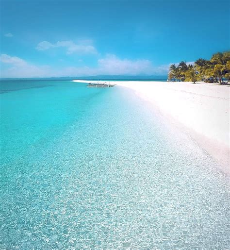 beach with white sand and blue water