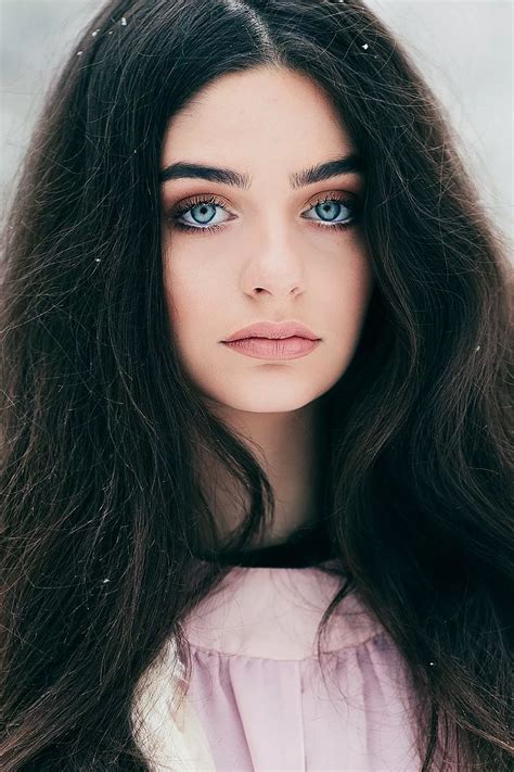 Beautiful Woman With Dark Hair And Blue Eyes