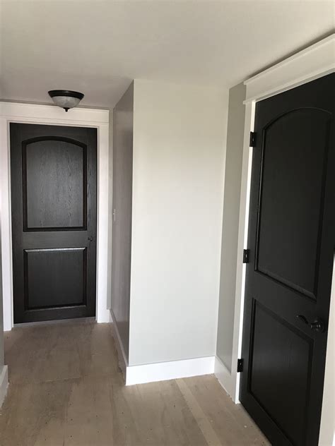 Matte black doors with gloss white trim and warm grey walls Warm grey
