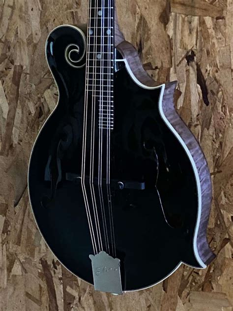 black and gold colored mandolin