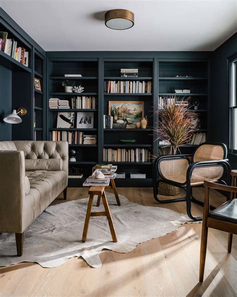 Black couch in living room with books