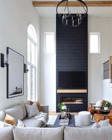 Black couch in living room with fireplace