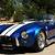 blue sports car with white stripes