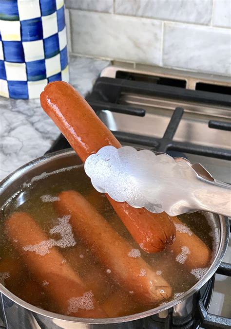 Boiling beef hot dogs