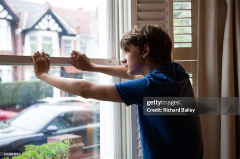 Boy Looking Out Window