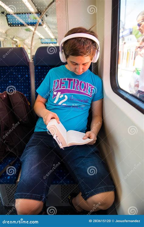 A boy reading on a train