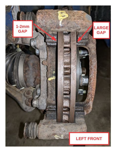 brake caliper bracket rubbing rotor