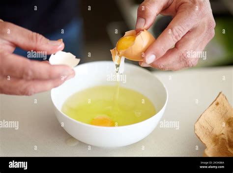 Breaking Eggs To Make An Omelette