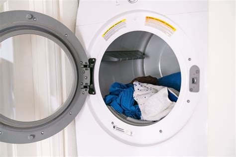 broken dryer with clothes inside
