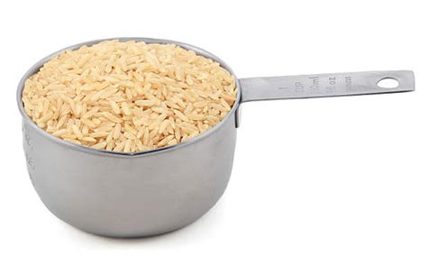 Measuring Cups Filled with Brown Rice and Water