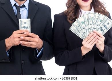 Business people holding dollars