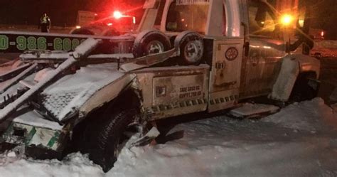 car hits tow truck in snow