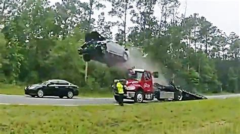 car launches off tow truck ramp