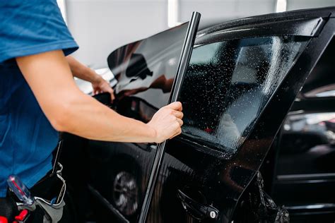 Male worker tinting car window, closeup Auto Trim Design