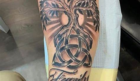 a person with a tattoo on their arm that has an image of a cross in the