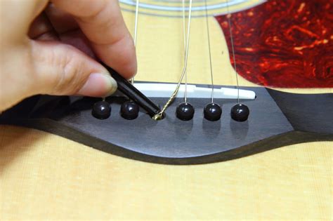 Changing Guitar Strings Bridge Pins