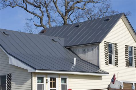charcoal grey metal roof white brick house