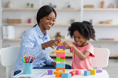 Child engaging in play therapy with blocks