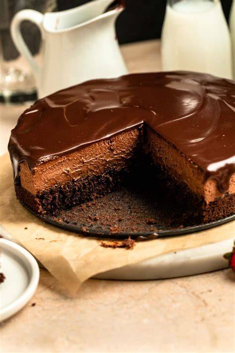 Chocolate mousse cake preparation with brownie layers and ganache