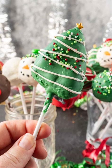 Gluten free Christmas tree cake pops arranged in a white stand on a