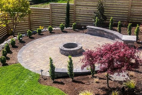 A circle shaped concrete paver patio, with attached semi