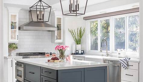 Elegant kitchen with white kitchen cabinets and espresso island Quartz