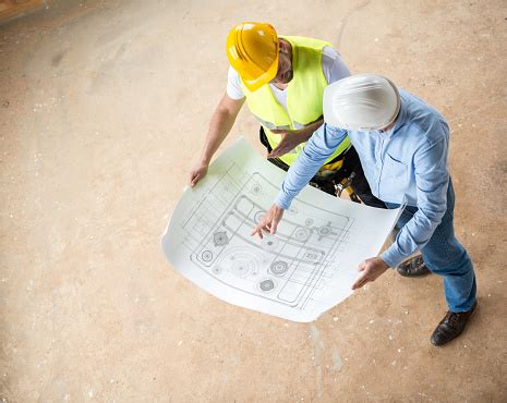 Image of a construction worker looking at a blueprint.