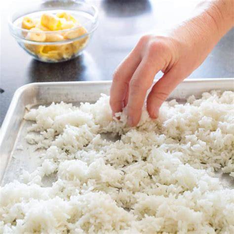 Cooked rice spread on a baking sheet