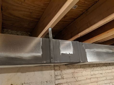 correct way to hang furnace trunk on a floor joist