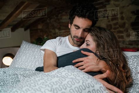 Couple Hugging in Bed