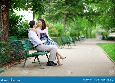 Couple hugging on bench