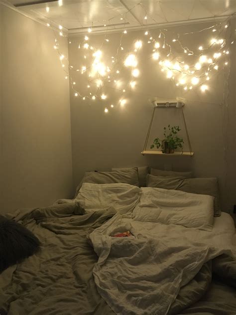 Cozy bedroom decorated with fourposter bed and fairy lights Fairy