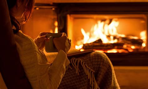 cozy person sitting by fireplace