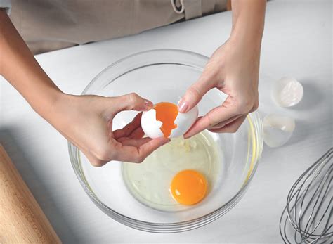 Cracking eggs into a pan