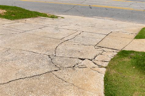 damaged driveway with cracks