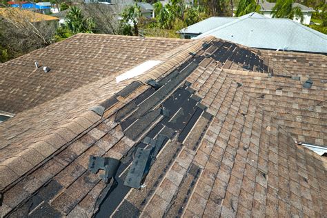 Damaged roof with shingles missing