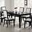 Dark wood extendible dining table with 6 white chairs in Ealing