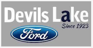A modern Devils Lake Ford dealership showcasing a variety of new Ford vehicles