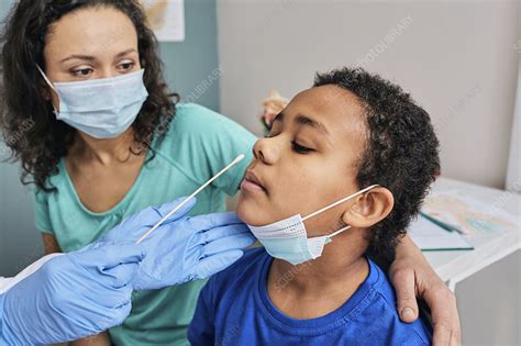 doctor taking nasal swab sample from patient