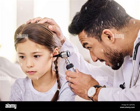 Doctors checking ears of patient